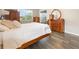 Well-lit bedroom with wood flooring, traditional furniture, and a view to the outside at 31961 Redtail Reserve Blvd, Sorrento, FL 32776