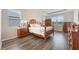 Bedroom with wood floors, tray ceilings, natural light, and traditional wood furniture at 31961 Redtail Reserve Blvd, Sorrento, FL 32776