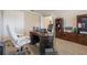 Well-lit home office featuring a large desk, comfortable chair, and ample storage with wood-look flooring at 31961 Redtail Reserve Blvd, Sorrento, FL 32776