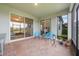 Spacious covered patio with brick flooring, outdoor seating, and sliding glass doors to the interior at 31961 Redtail Reserve Blvd, Sorrento, FL 32776