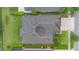 Aerial view showing a detailed roof and landscaped backyard, with an adjacent street at 31961 Redtail Reserve Blvd, Sorrento, FL 32776
