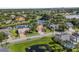 This aerial view highlights a home with lush landscaping and a pond, offering serene neighborhood scenery at 3713 Ocita Dr, Orlando, FL 32837