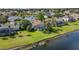 Aerial view of a single-Gathering home and yard backing to a lake at 3713 Ocita Dr, Orlando, FL 32837
