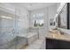 Luxurious bathroom featuring a soaking tub, glass-enclosed shower, and granite countertops at 3713 Ocita Dr, Orlando, FL 32837