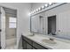 Bathroom featuring dual sinks, a large mirror and a shower/tub combo at 3713 Ocita Dr, Orlando, FL 32837