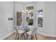 Dining area with glass table, modern chandelier and backyard pool view at 3713 Ocita Dr, Orlando, FL 32837