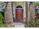 Charming red double front door with brick columns and half-round window overhead offers a welcoming entrance at 3713 Ocita Dr, Orlando, FL 32837