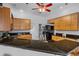 Stylish kitchen featuring black countertops, wood cabinets, and modern appliances at 3713 Ocita Dr, Orlando, FL 32837