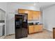 Kitchen featuring wood cabinets, granite countertops, and stainless steel refrigerator at 3713 Ocita Dr, Orlando, FL 32837