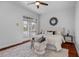 Sun-filled main bedroom with hardwood floors, a plush rug, ceiling fan and a seating area by the window at 3713 Ocita Dr, Orlando, FL 32837