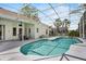 A screened-in pool has a patio area with an outdoor table and chairs, perfect for outdoor dining and entertaining at 3713 Ocita Dr, Orlando, FL 32837