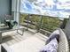 Inviting balcony lounge with comfortable seating and serene neighborhood views beyond railing at 4751 Clock Tower Dr # 304, Kissimmee, FL 34746