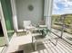 Relaxing balcony with comfortable seating and beautiful outdoor views beyond glass doors at 4751 Clock Tower Dr # 304, Kissimmee, FL 34746