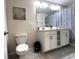 Bathroom features white vanity, a patterned shower curtain, and tiled floors for a clean look at 4751 Clock Tower Dr # 304, Kissimmee, FL 34746
