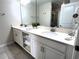 Bright bathroom features a double vanity with modern fixtures and ample storage space at 4751 Clock Tower Dr # 304, Kissimmee, FL 34746