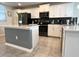 Contemporary kitchen with stainless steel appliances, white cabinets, and a functional kitchen island at 4751 Clock Tower Dr # 304, Kissimmee, FL 34746