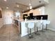 Modern kitchen with white cabinets, stainless steel appliances, and sleek bar seating at 4751 Clock Tower Dr # 304, Kissimmee, FL 34746