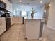 Modern kitchen with stainless steel appliances, white cabinets, and a functional kitchen island at 4751 Clock Tower Dr # 304, Kissimmee, FL 34746