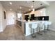 Open kitchen featuring white cabinets, island with seating, and stainless steel appliances at 4751 Clock Tower Dr # 304, Kissimmee, FL 34746