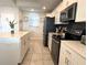 Modern kitchen with stainless steel appliances, white cabinets, and a functional kitchen island at 4751 Clock Tower Dr # 304, Kissimmee, FL 34746