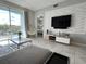 Bright living room with modern furniture, textured wall paneling, and an outdoor view at 4751 Clock Tower Dr # 304, Kissimmee, FL 34746