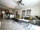 Open concept living room with modern furnishings and decor, connecting to the dining area and kitchen at 4751 Clock Tower Dr # 304, Kissimmee, FL 34746