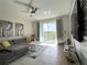 Cozy living space with comfortable seating, a ceiling fan, and access to a balcony at 4751 Clock Tower Dr # 304, Kissimmee, FL 34746