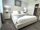 Serene main bedroom with a luxurious bed, stylish lamps, and soothing color scheme at 4751 Clock Tower Dr # 304, Kissimmee, FL 34746