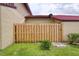 Enclosed backyard with a wooden fence, grass, and access to the home at 513 Hunter Cir # 513, Kissimmee, FL 34758