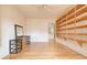 Bedroom with wood flooring, ceiling fan, shelving, and a doorway leading to a bathroom at 513 Hunter Cir # 513, Kissimmee, FL 34758