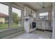 Bright kitchen features white cabinets, appliances, and a large window with neighborhood views at 513 Hunter Cir # 513, Kissimmee, FL 34758