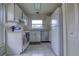 Functional kitchen featuring white cabinetry, stainless steel appliances, and tile flooring at 513 Hunter Cir # 513, Kissimmee, FL 34758