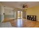Open living area with hardwood floors, ceiling fan, and sliding glass doors to the outside at 513 Hunter Cir # 513, Kissimmee, FL 34758