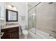 Renovated bathroom with a white toilet, modern shower-tub and dark wood vanity at 528 Greely St, Orlando, FL 32804