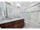Large bathroom featuring a double vanity, granite countertops, and tile shower-tub combo at 528 Greely St, Orlando, FL 32804