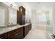 Elegant bathroom features granite countertops, dark wood cabinets, tub, and glass enclosed shower at 528 Greely St, Orlando, FL 32804