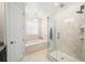 Bright bathroom featuring a glass-enclosed shower, soaking tub and elegant chandelier at 528 Greely St, Orlando, FL 32804