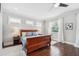 Bright primary bedroom featuring hardwood floors, large windows, and neutral decor at 528 Greely St, Orlando, FL 32804