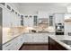 Modern kitchen with white cabinetry, stainless steel appliances, and granite countertops at 528 Greely St, Orlando, FL 32804