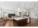 Bright open-concept living space featuring a kitchen island with granite countertops and a dining area at 528 Greely St, Orlando, FL 32804