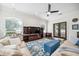 Inviting living room features large windows, a dark wooden entertainment center, and hardwood floors at 528 Greely St, Orlando, FL 32804