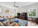 Spacious living room with large windows, comfortable seating, hardwood floors, and a dark wood entertainment center at 528 Greely St, Orlando, FL 32804