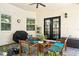 Cozy outdoor patio with brick flooring, modern seating, ceiling fan, and a white brick exterior at 528 Greely St, Orlando, FL 32804