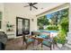 Outdoor patio featuring brick flooring, a ceiling fan, a white brick exterior, and a pool view at 528 Greely St, Orlando, FL 32804