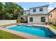 Beautiful backyard featuring a large pool, white fence, and a covered lanai at 528 Greely St, Orlando, FL 32804