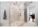 Luxurious bathroom showcasing an elegant, glass-enclosed walk-in shower with marble tiling at 528 Greely St, Orlando, FL 32804