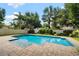 Backyard featuring a large swimming pool with brick trim, lush greenery, and a privacy fence at 528 Greely St, Orlando, FL 32804