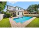 Backyard featuring a large swimming pool with brick trim, manicured lawn, and a covered patio at 528 Greely St, Orlando, FL 32804