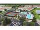 Aerial view of community amenities showcasing a pool, tennis courts, playground, and lush landscaping at 530 Harriswood Ct, Davenport, FL 33837