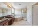 A spacious bathroom with double sinks, large garden tub, glass shower and neutral tile at 530 Harriswood Ct, Davenport, FL 33837